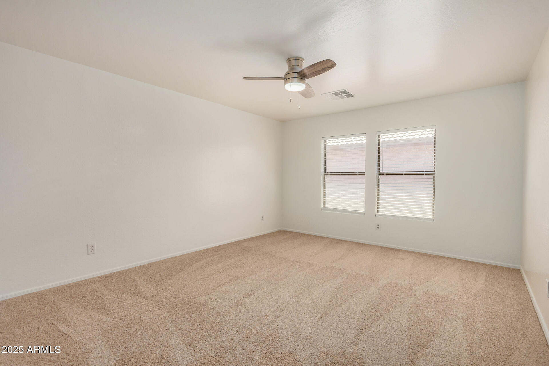 18475 North Madison Road Maricopa, AZ 85139 - Photo 26 of 40 an empty room with a window and ceiling fan