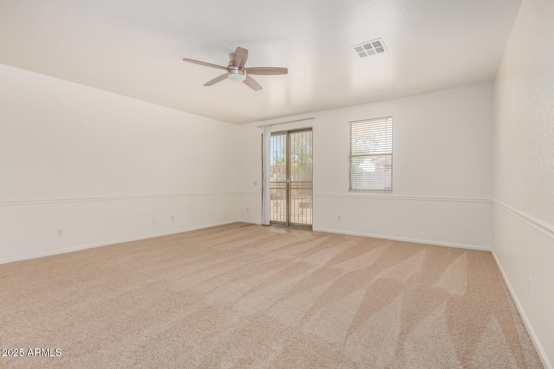 18475 North Madison Road Maricopa, AZ 85139 - Photo 7 of 40 a view of an empty room with a window