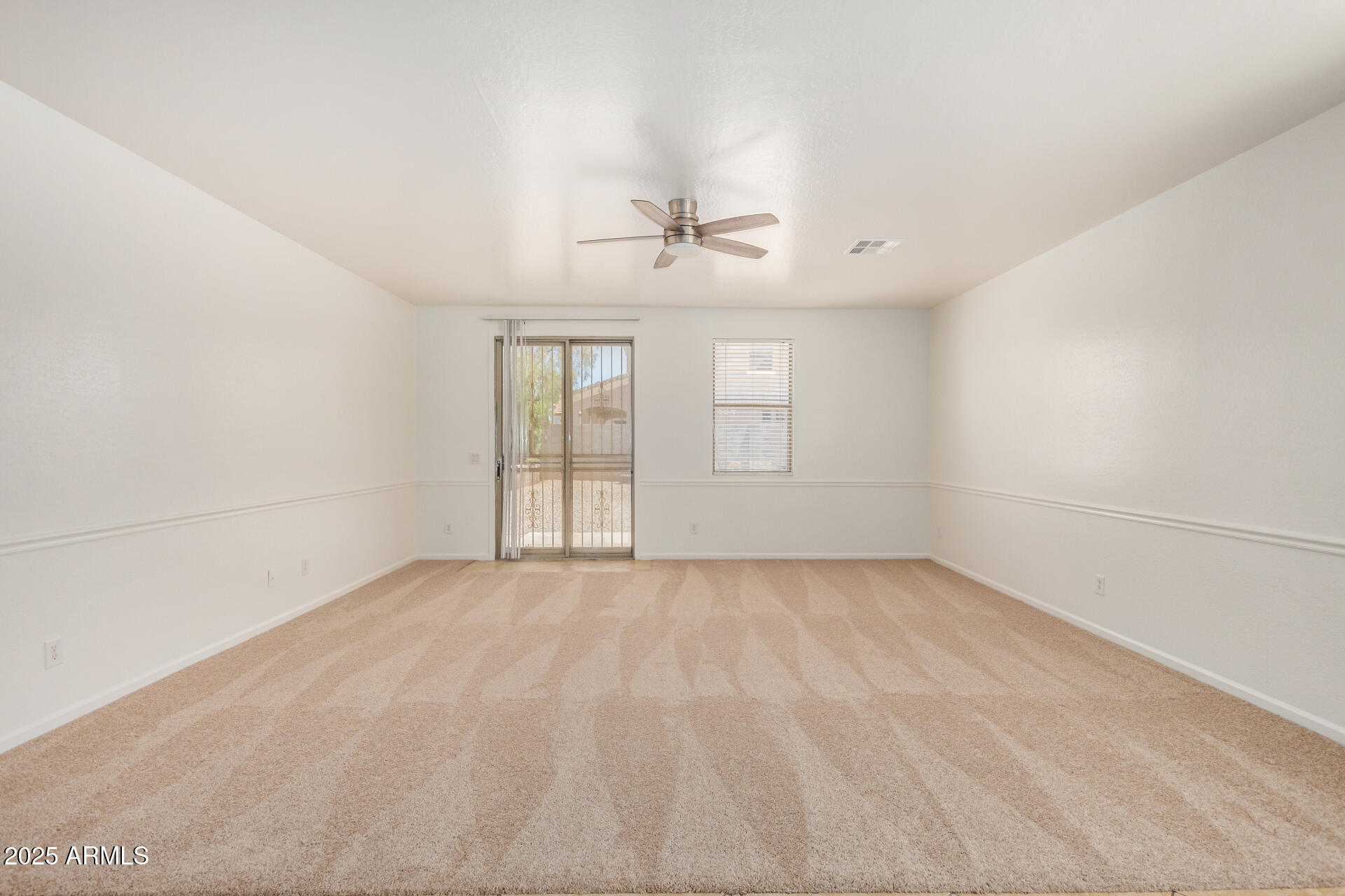 18475 North Madison Road Maricopa, AZ 85139 - Photo 8 of 40 a view of an empty room with a window