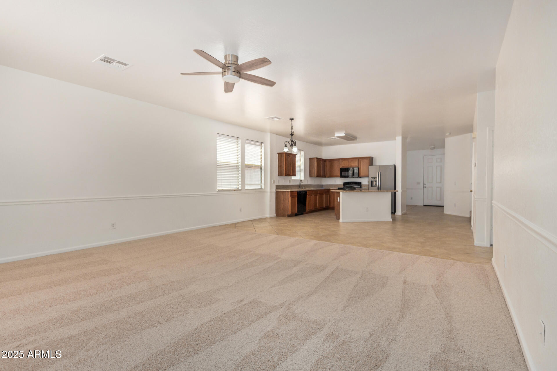18475 North Madison Road Maricopa, AZ 85139 - Photo 10 of 40 a view of empty room with kitchen and window