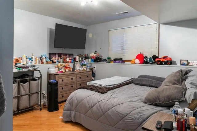 a bedroom with furniture and a flat screen tv