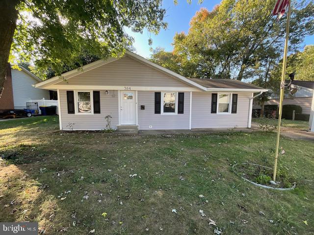 384 Post Boulevard Dover, DE 19904 - Photo 1 of 13 a front view of a house with a garden