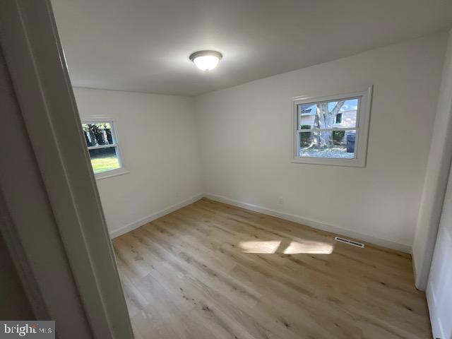 384 Post Boulevard Dover, DE 19904 - Photo 11 of 13 an empty room with wooden floor and windows