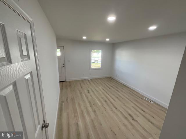384 Post Boulevard Dover, DE 19904 - Photo 5 of 13 an empty room with wooden floor and windows