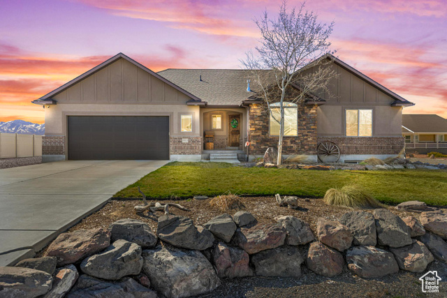 4345 Rose Springs Road Erda, UT 84074 - Photo 1 of 1 View of front of property featuring brick siding, board and batten siding, driveway, and a garage