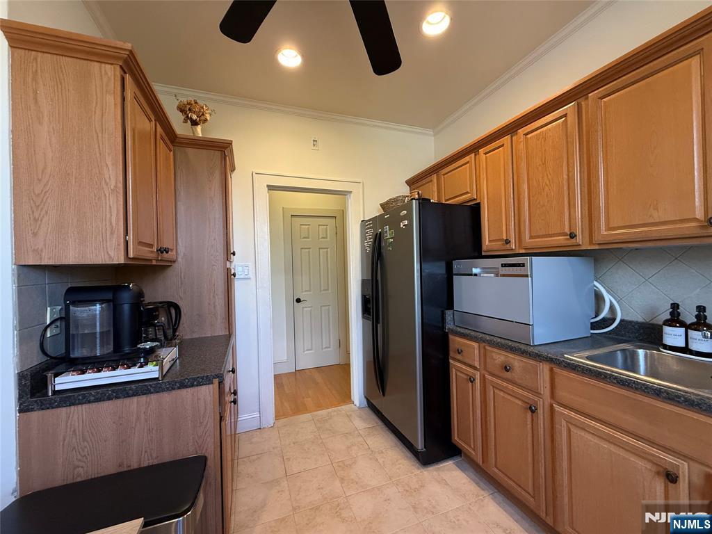 215 Orient Way, Unit C2 Rutherford, NJ 07070 - Photo 12 of 25 a kitchen with stainless steel appliances granite countertop a refrigerator and a stove top oven