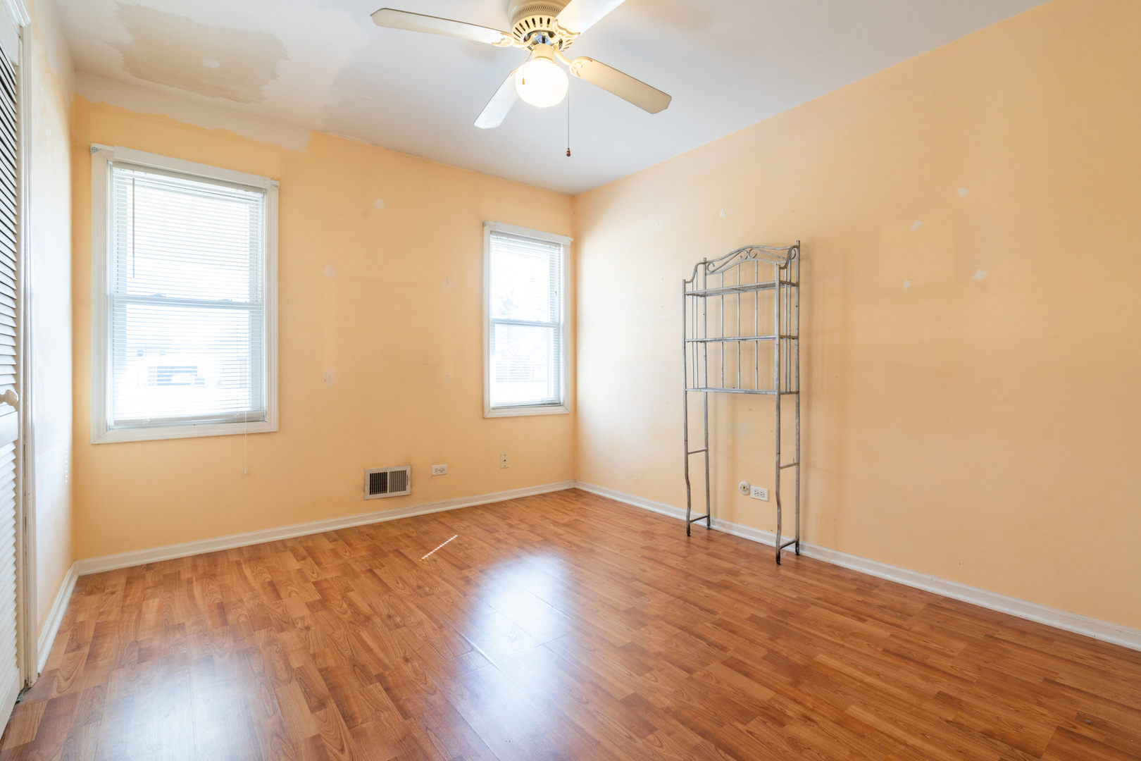 5912 109th Place Chicago Ridge, IL 60415 - Photo 14 of 21 an empty room with wooden floor chandelier fan and windows