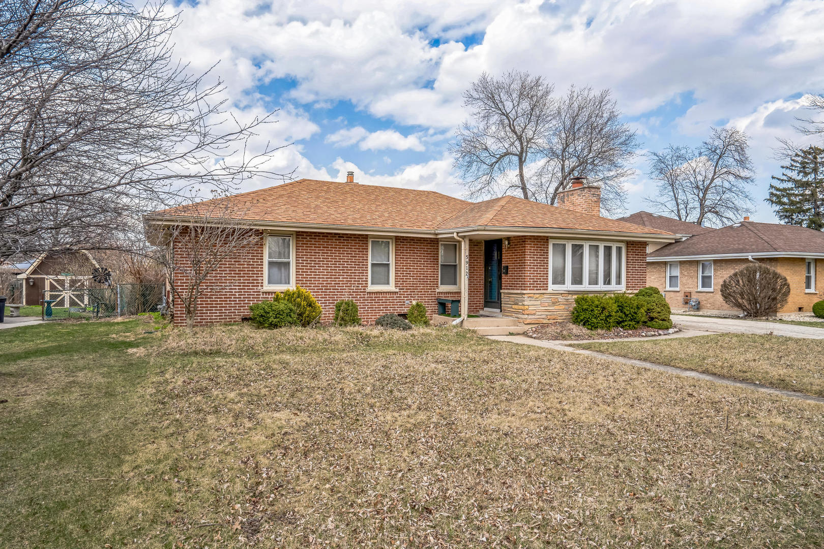 5912 109th Place Chicago Ridge, IL 60415 - Photo 2 of 21 a front view of a house with a garden