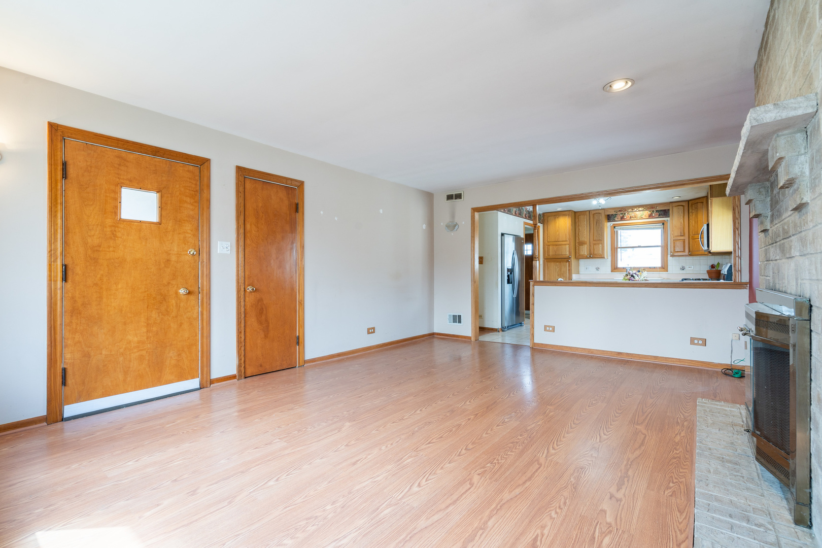 5912 109th Place Chicago Ridge, IL 60415 - Photo 6 of 21 an empty room with a window and wooden floor