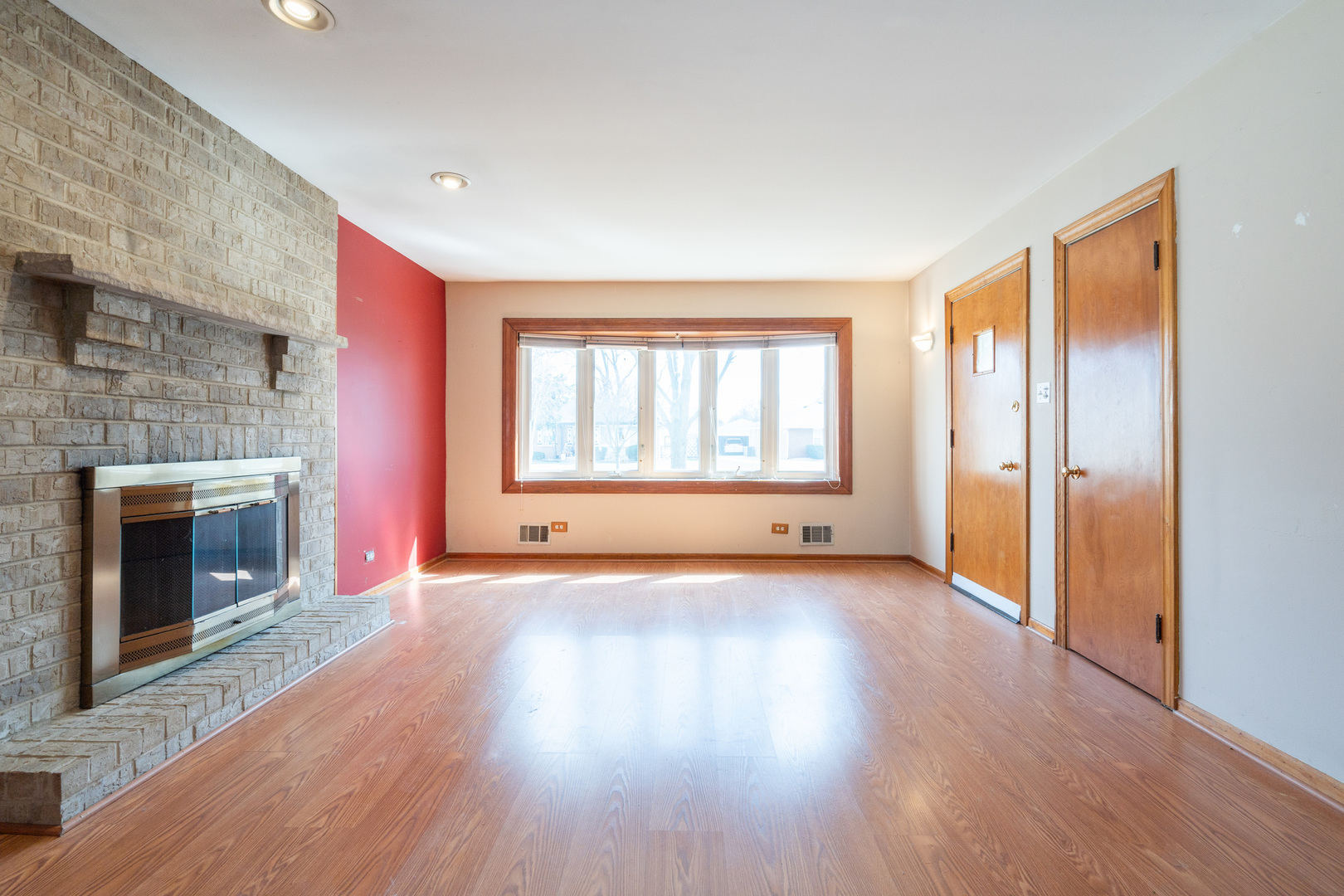 5912 109th Place Chicago Ridge, IL 60415 - Photo 7 of 21 a view of empty room with wooden floor and fireplace