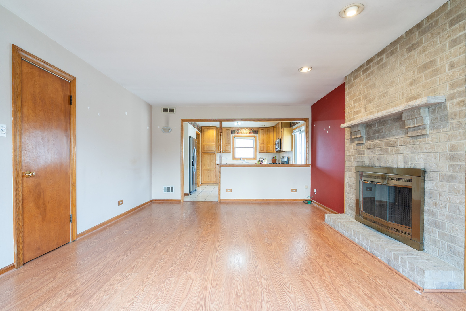 5912 109th Place Chicago Ridge, IL 60415 - Photo 8 of 21 a view of an empty room with a fireplace and a window