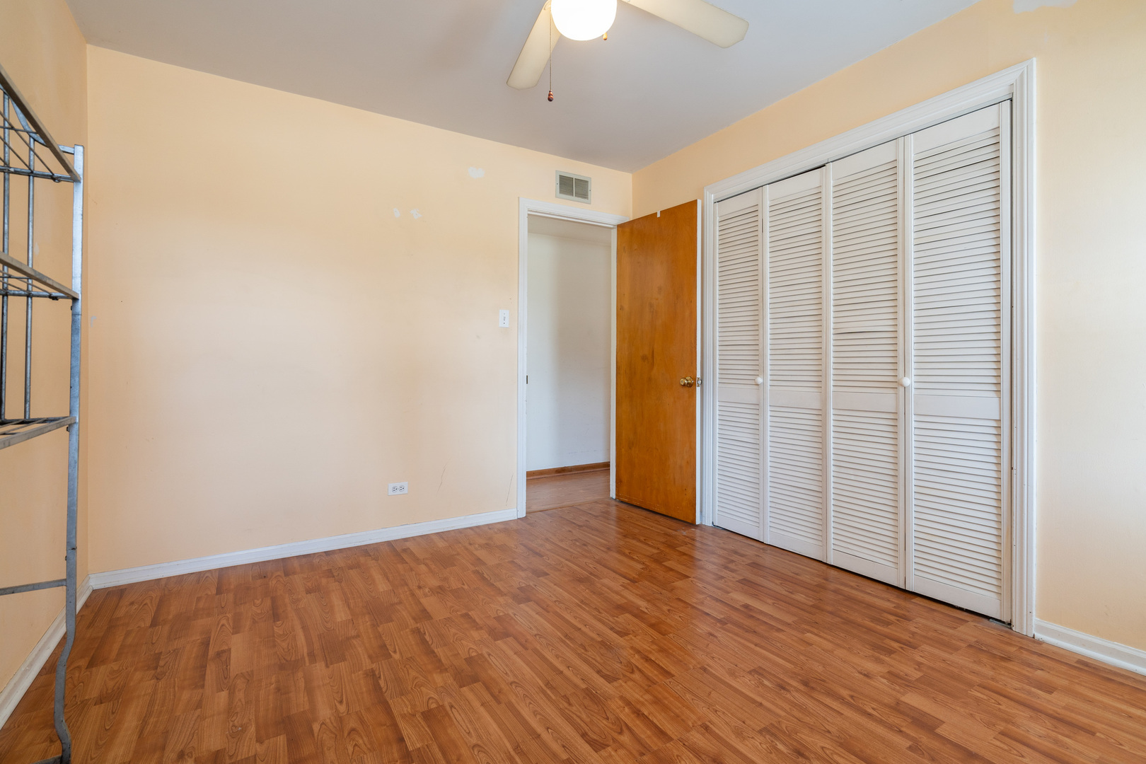 5912 109th Place Chicago Ridge, IL 60415 - Photo 9 of 21 a view of an empty room with wooden floor a ceiling fan