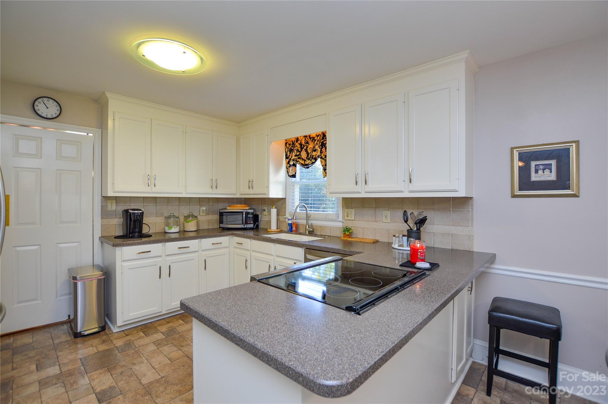 5215 Rocky River Road Charlotte, NC 28215 - Photo 11 of 33 a kitchen with a sink a stove and cabinets
