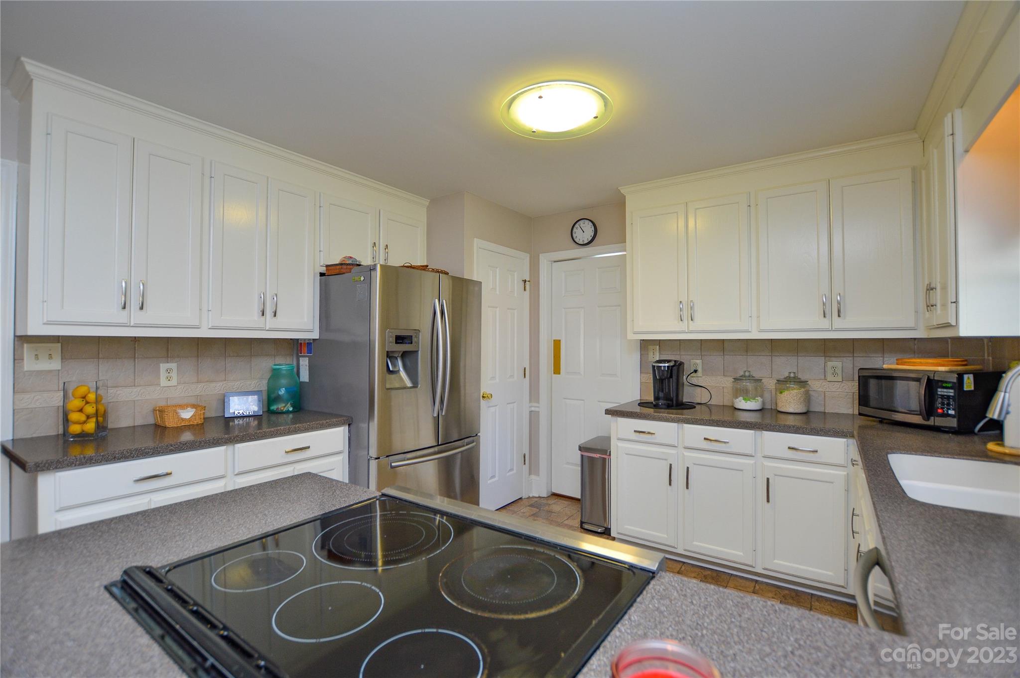 5215 Rocky River Road Charlotte, NC 28215 - Photo 12 of 33 a kitchen with stainless steel appliances granite countertop a sink stove and refrigerator