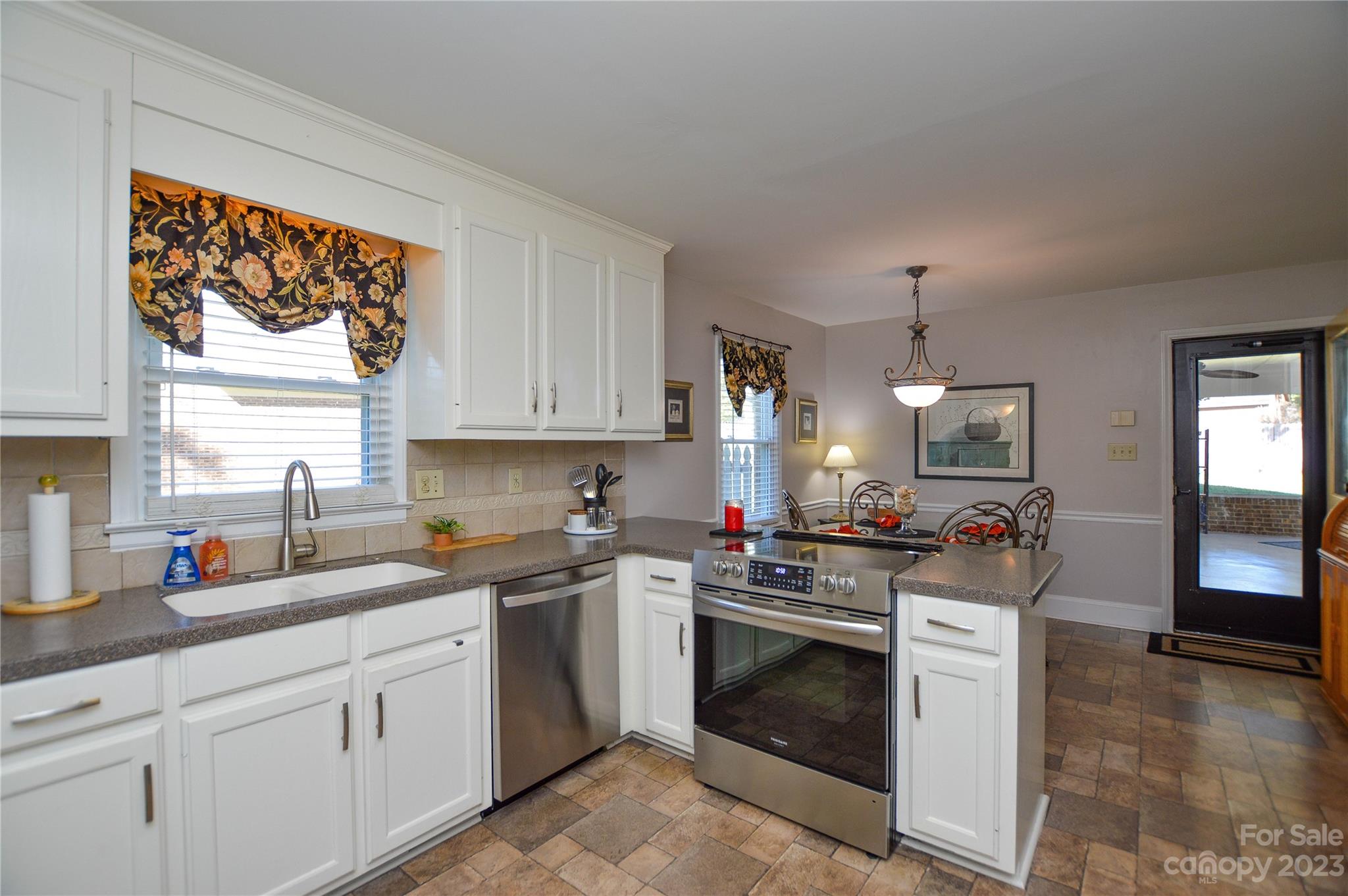5215 Rocky River Road Charlotte, NC 28215 - Photo 13 of 33 a kitchen with sink cabinets and window