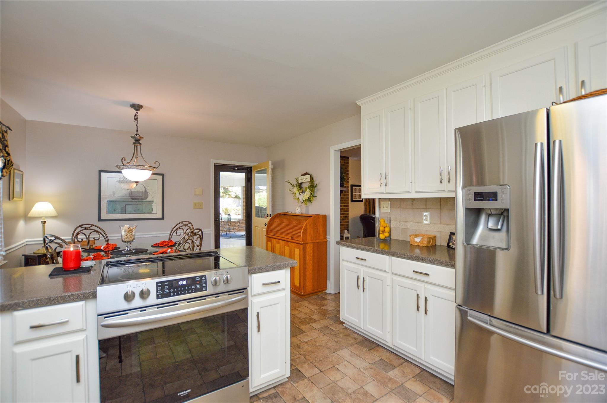 5215 Rocky River Road Charlotte, NC 28215 - Photo 14 of 33 a kitchen with stainless steel appliances a stove refrigerator sink and cabinets