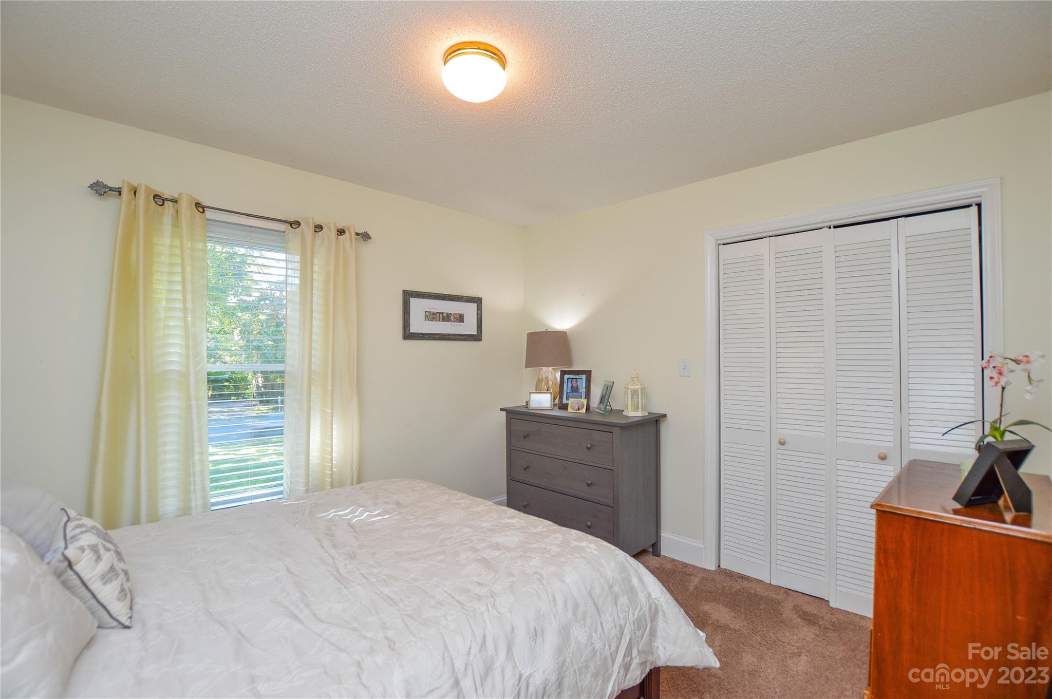 5215 Rocky River Road Charlotte, NC 28215 - Photo 16 of 33 a bedroom with a bed and a window