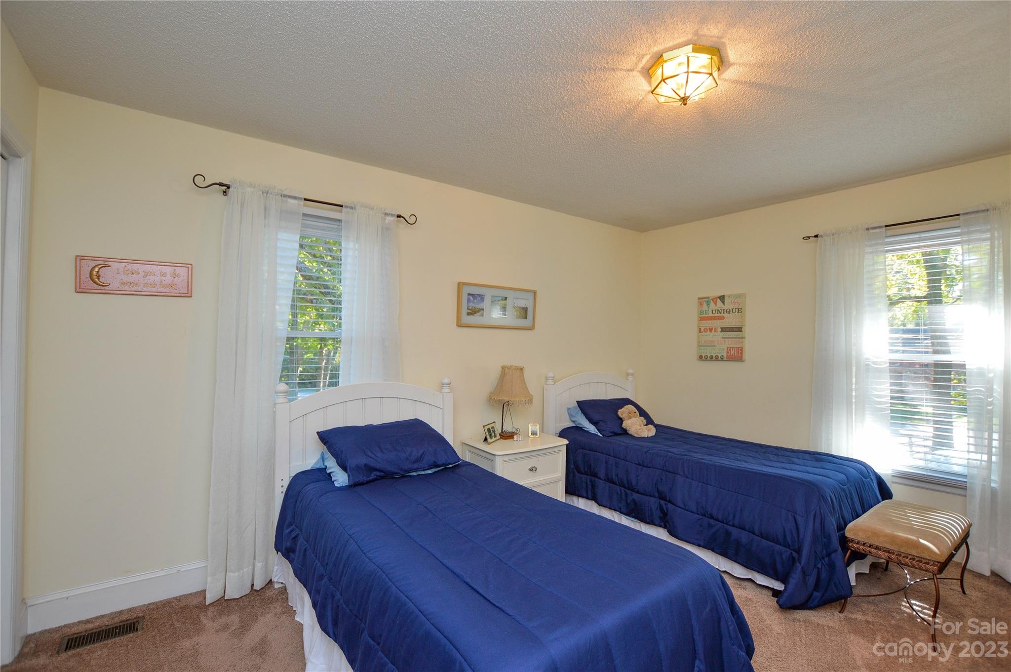 5215 Rocky River Road Charlotte, NC 28215 - Photo 18 of 33 a bedroom with two beds and a window