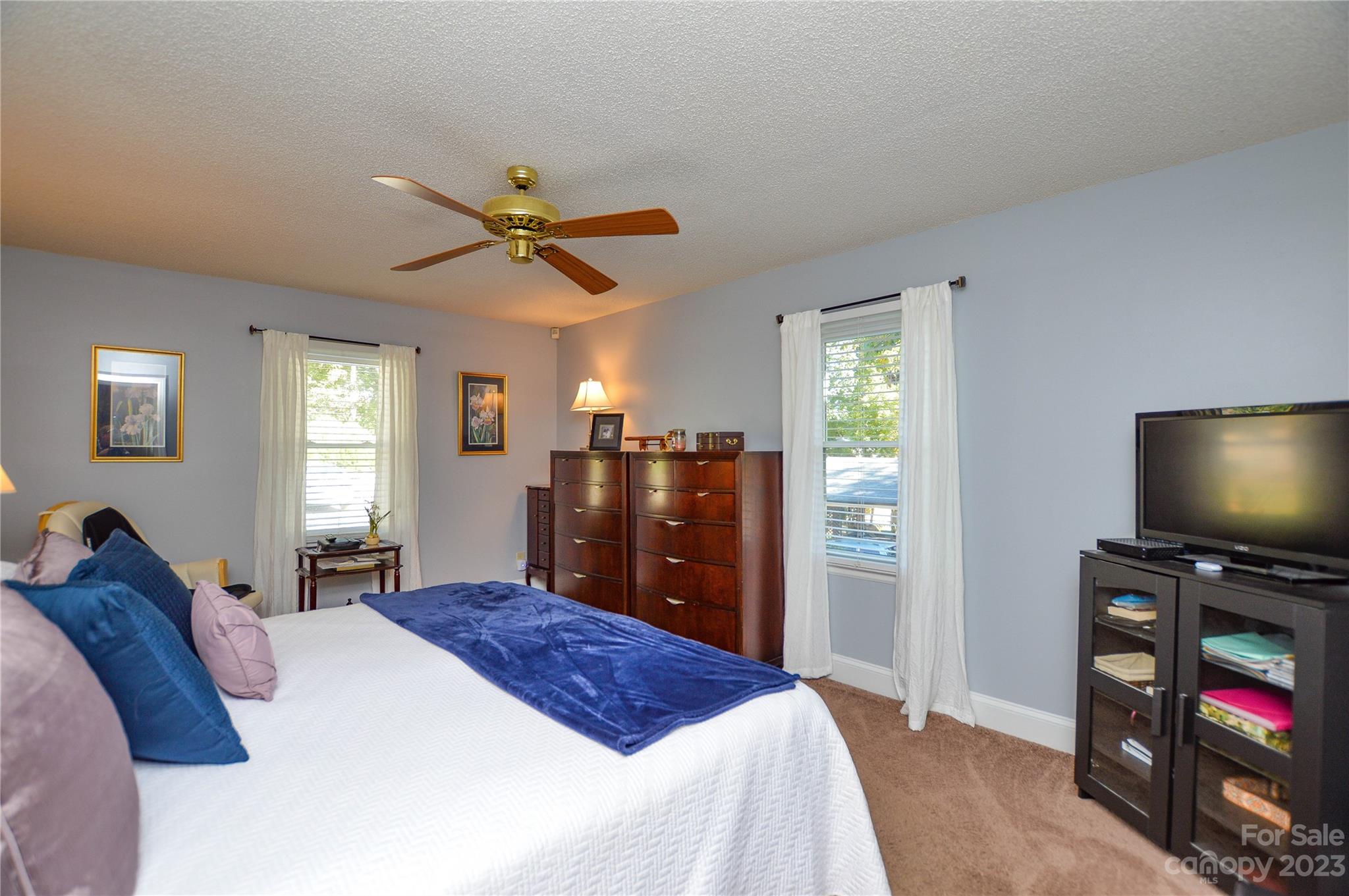 5215 Rocky River Road Charlotte, NC 28215 - Photo 20 of 33 a bedroom with a bed and a flat screen tv