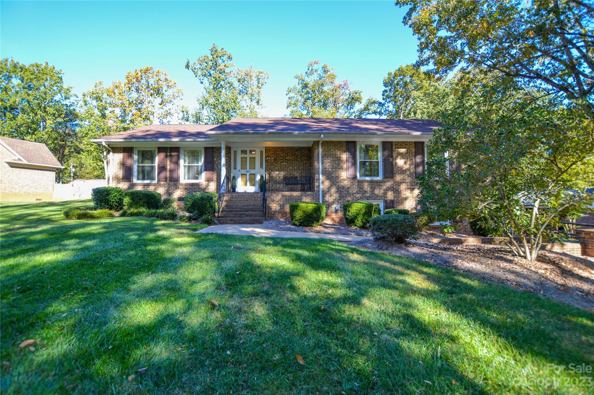 5215 Rocky River Road Charlotte, NC 28215 - Photo 2 of 33 a front view of a house with garden