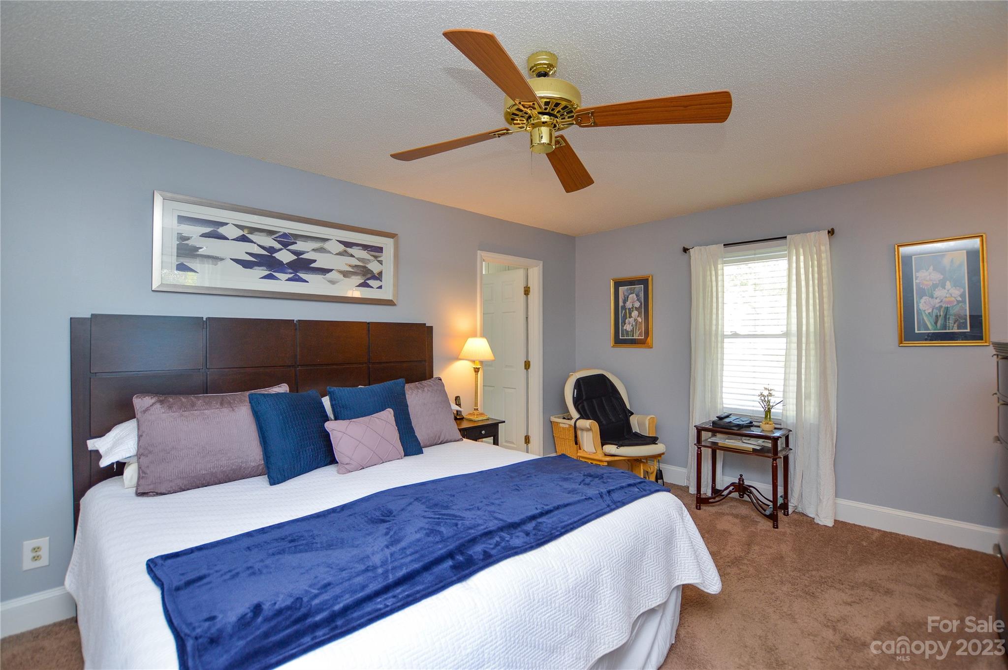 5215 Rocky River Road Charlotte, NC 28215 - Photo 21 of 33 a bedroom with bed and a chandelier