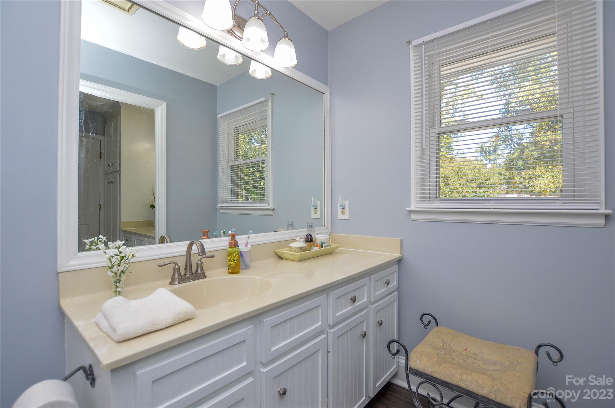 5215 Rocky River Road Charlotte, NC 28215 - Photo 24 of 33 a bathroom with a sink vanity granite and a mirror