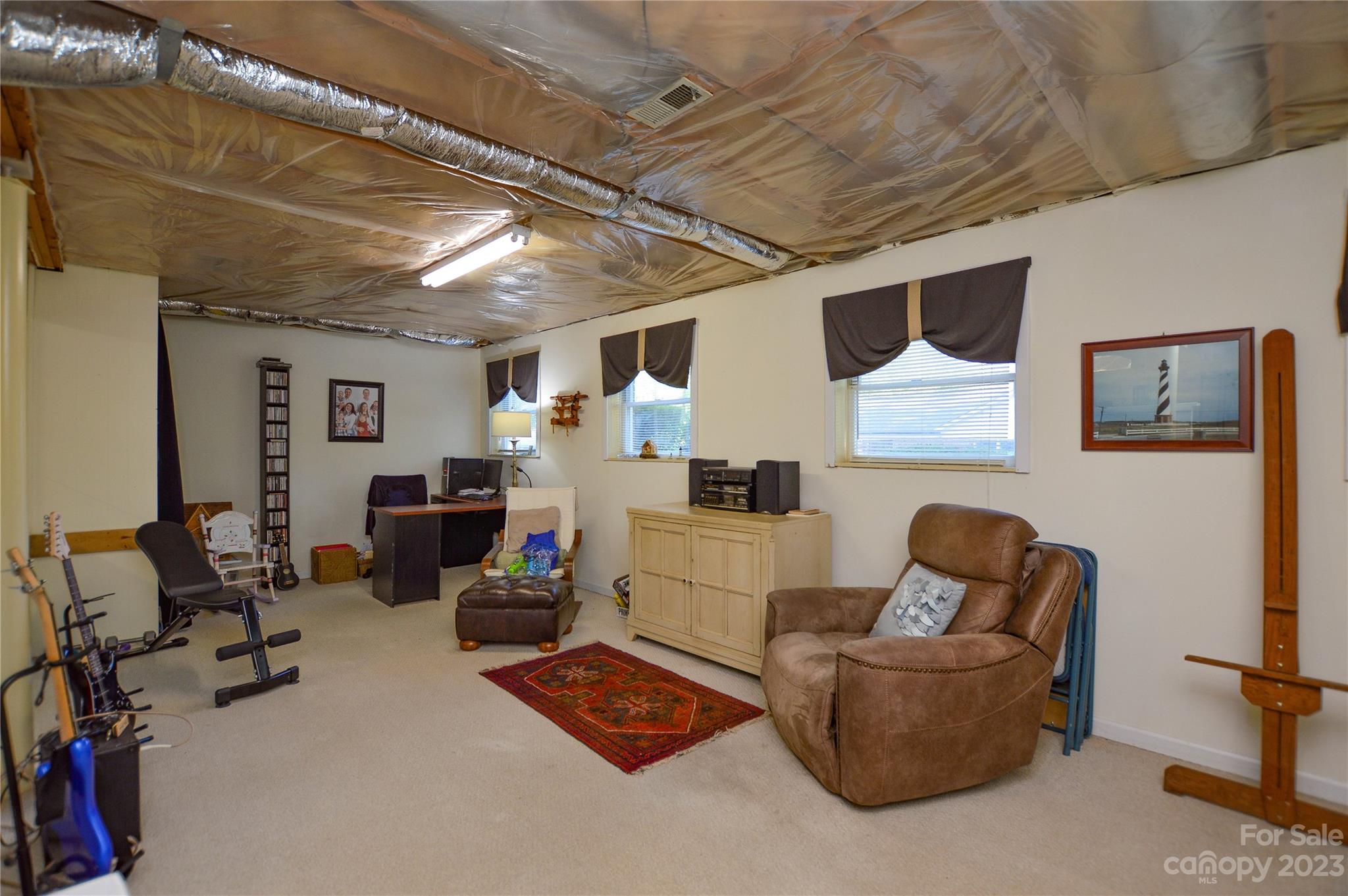 5215 Rocky River Road Charlotte, NC 28215 - Photo 26 of 33 a living room with furniture and a flat screen tv