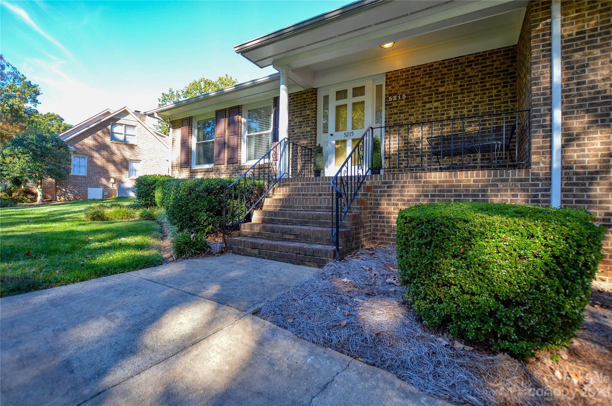 5215 Rocky River Road Charlotte, NC 28215 - Photo 3 of 33 a front view of a house with garden