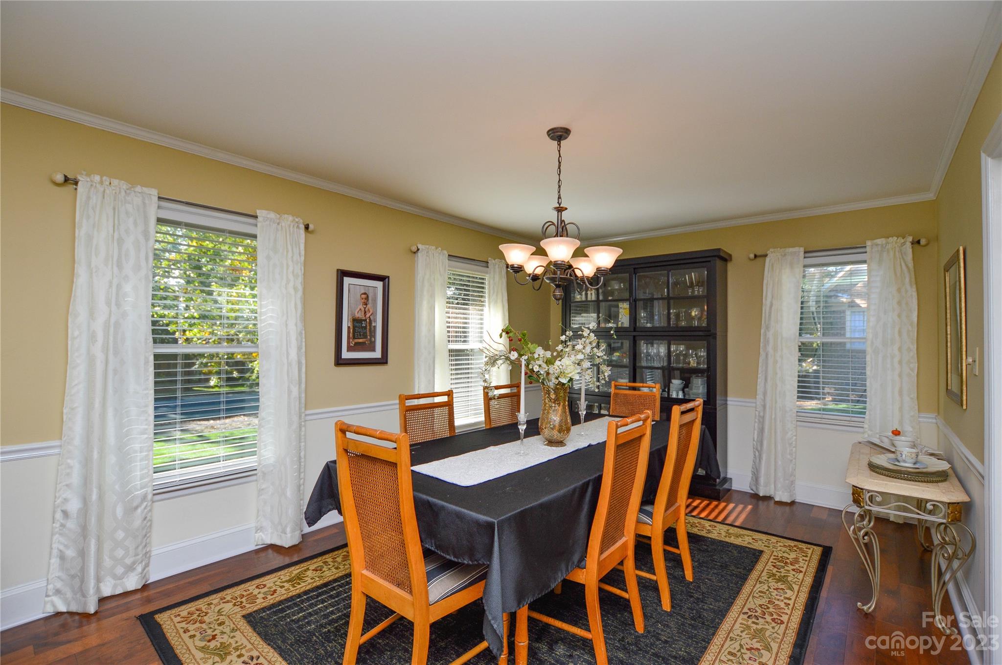 5215 Rocky River Road Charlotte, NC 28215 - Photo 10 of 33 a dining room with furniture a chandelier and wooden floor