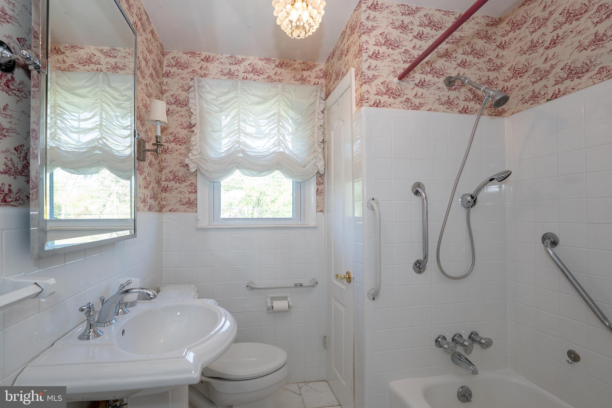 262 Lewis Road Springfield, PA 19064 - Photo 5 of 11 a bathroom with a granite countertop sink a toilet and shower
