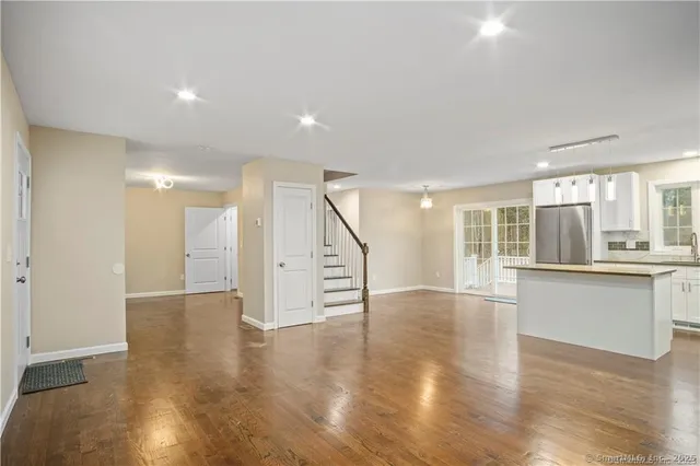 a kitchen with kitchen island a counter top space a sink stainless steel appliances and cabinets