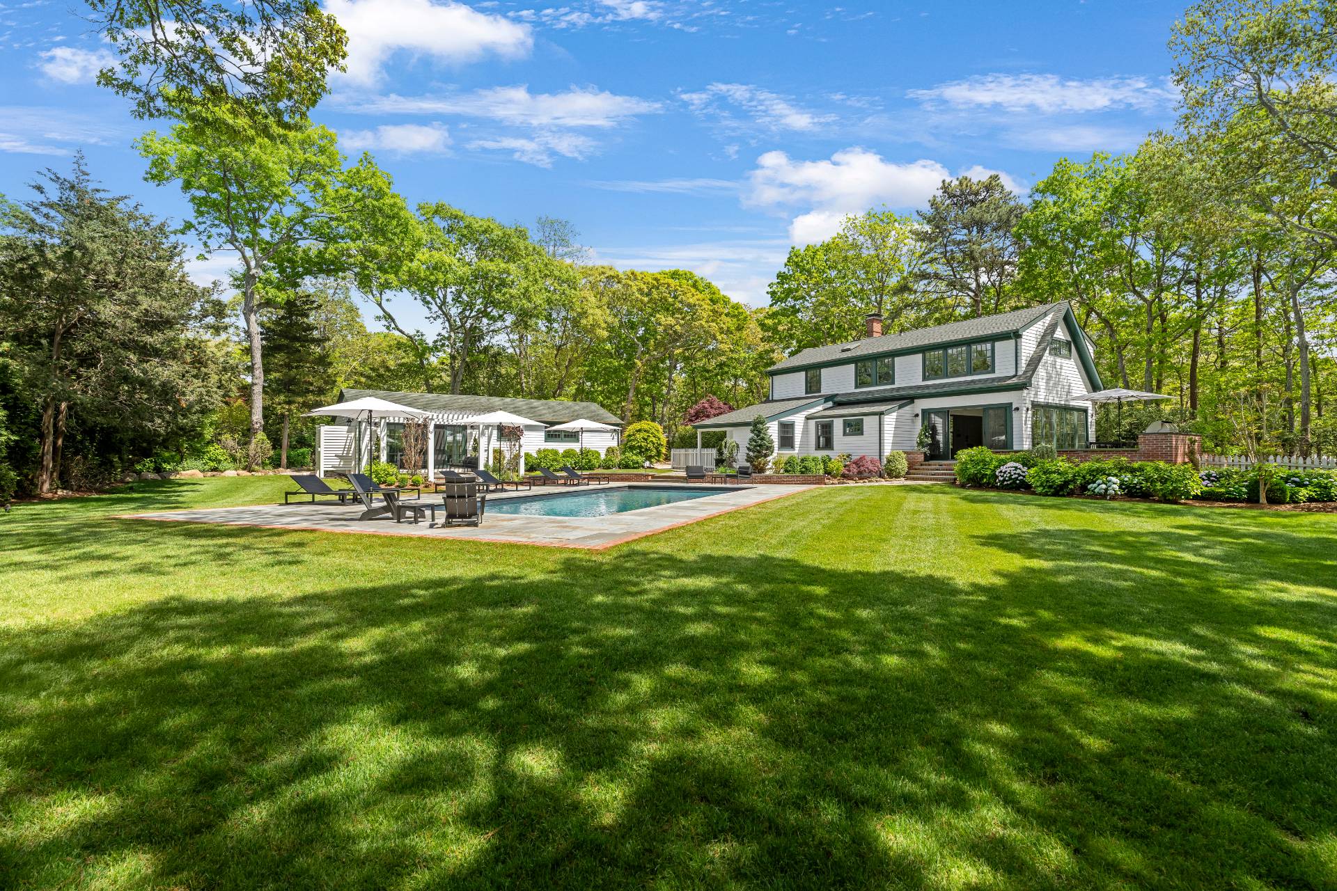 91 East Tiana Road Hampton Bays, NY 11946 - Photo 43 of 46 a house view with swimming pool and garden