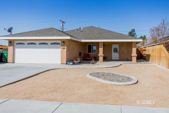 1013 Sims Street Ridgecrest, CA 93555 - Photo 2 of 33 a view of a house with roof and a yard