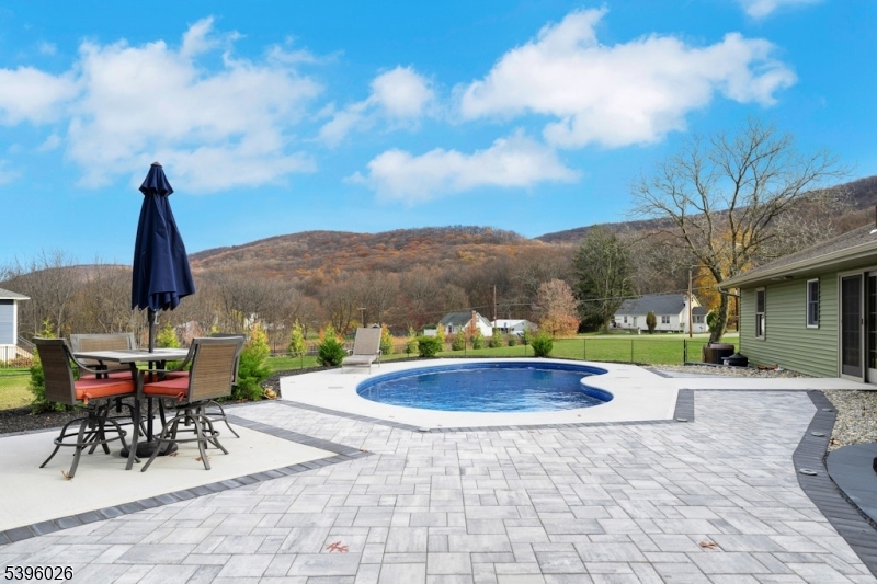 a view of swimming pool with outdoor seating and plants