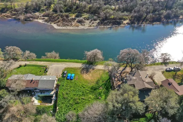 an aerial view of a house with a lake view