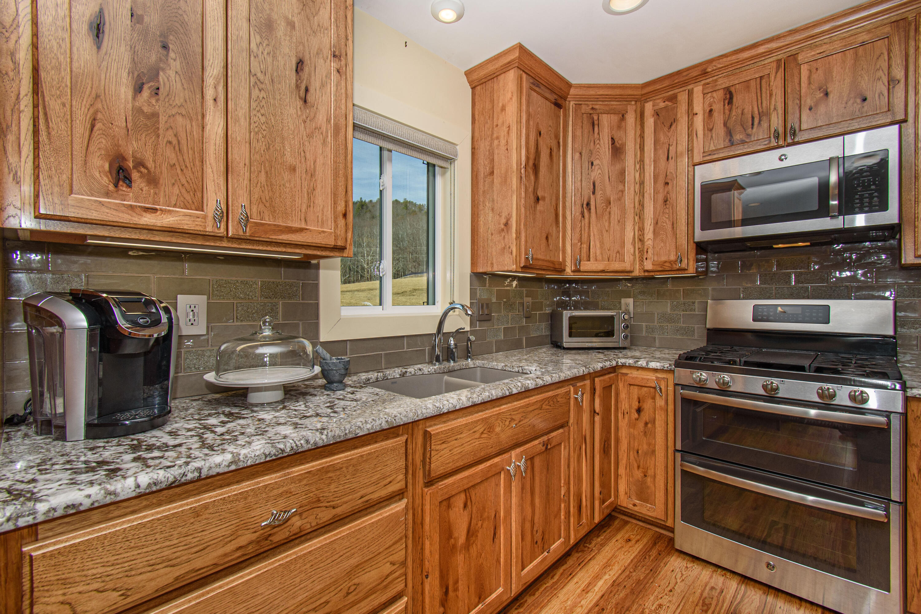 5600 Mt Tabor Road Blacksburg, VA 24060 - Photo 65 of 99 a kitchen with granite countertop a sink and a stove top oven
