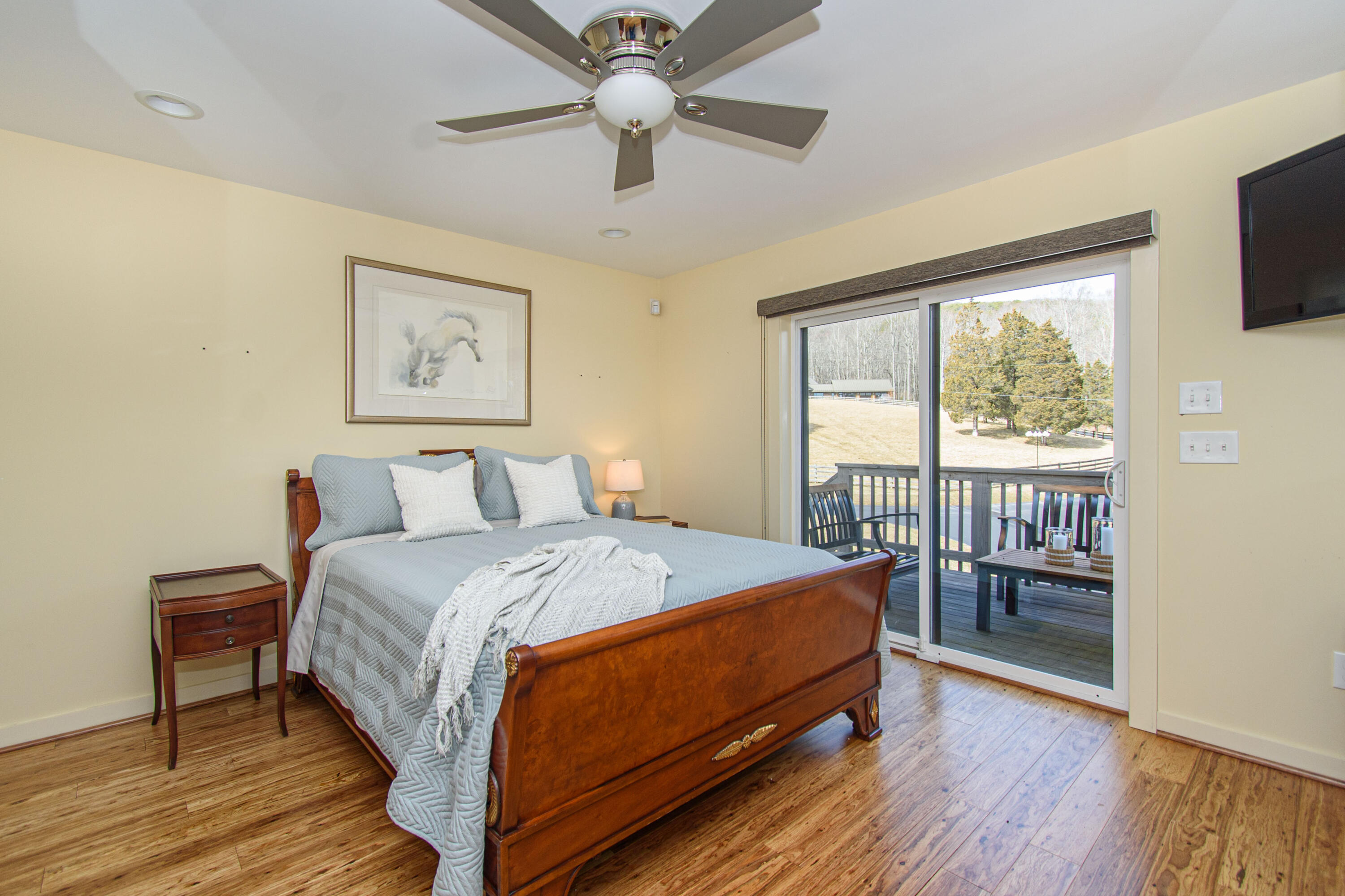 5600 Mt Tabor Road Blacksburg, VA 24060 - Photo 69 of 99 a bedroom with a bed and a large window with wooden floor