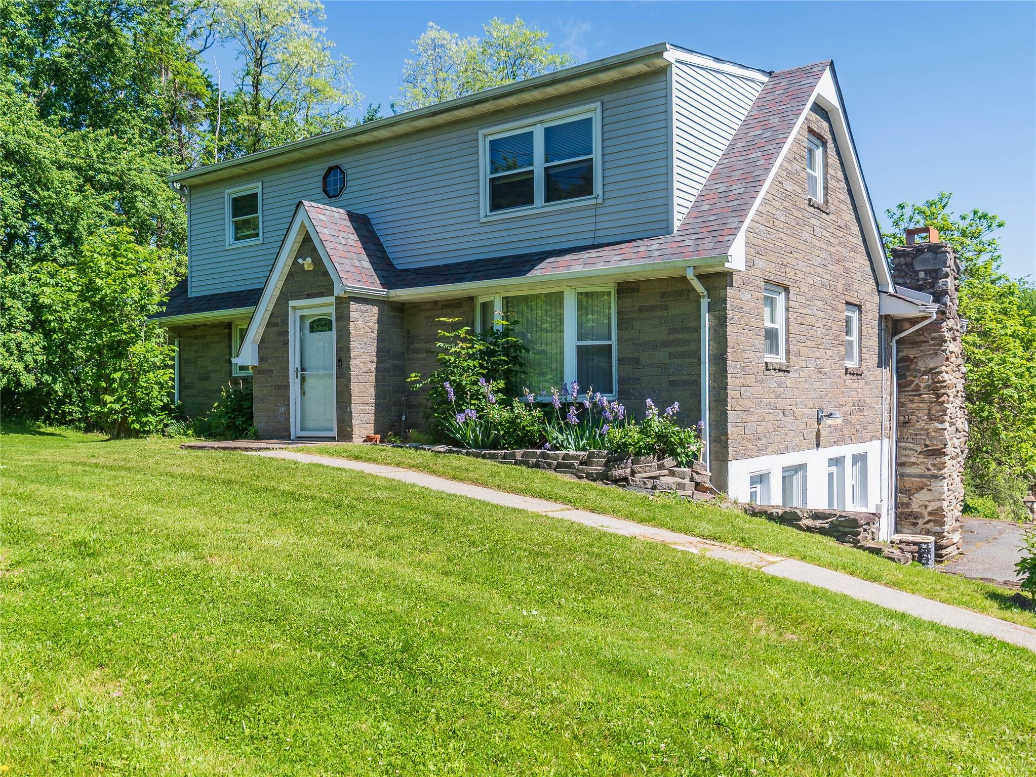 57 East Rock Cut Road Walden, NY 12586 - Photo 2 of 27 View of front of home with a front lawn, stone siding, and a shingled roof