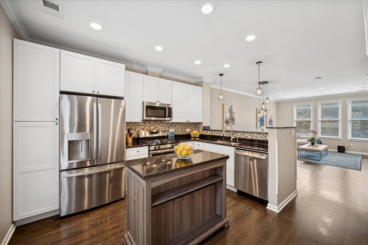 634 West Oak Street Chicago, IL 60610 - Photo 15 of 34 a kitchen with stainless steel appliances and wooden cabinets