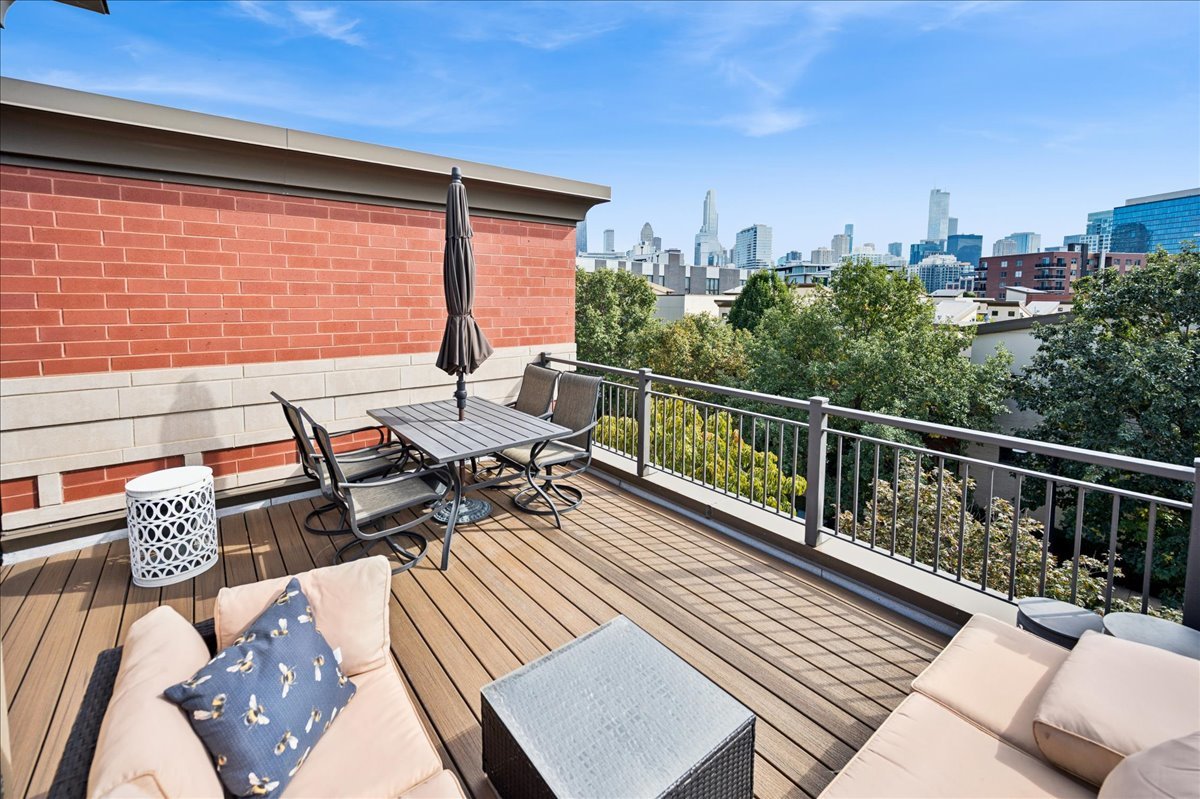 634 West Oak Street Chicago, IL 60610 - Photo 26 of 34 a view of balcony with chairs and wooden floor