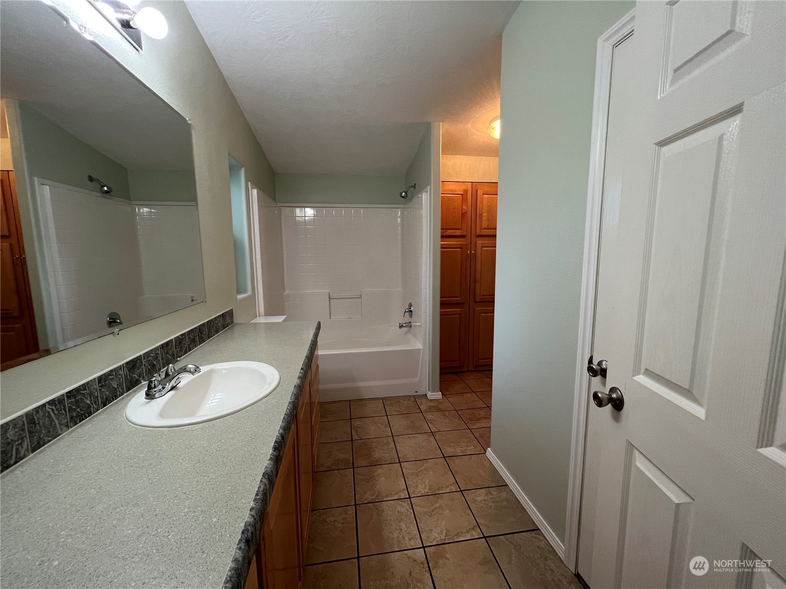 827 Cousins Road, Unit 27 Chehalis, WA 98532 - Photo 19 of 38 a bathroom with a granite countertop sink a mirror and a shower