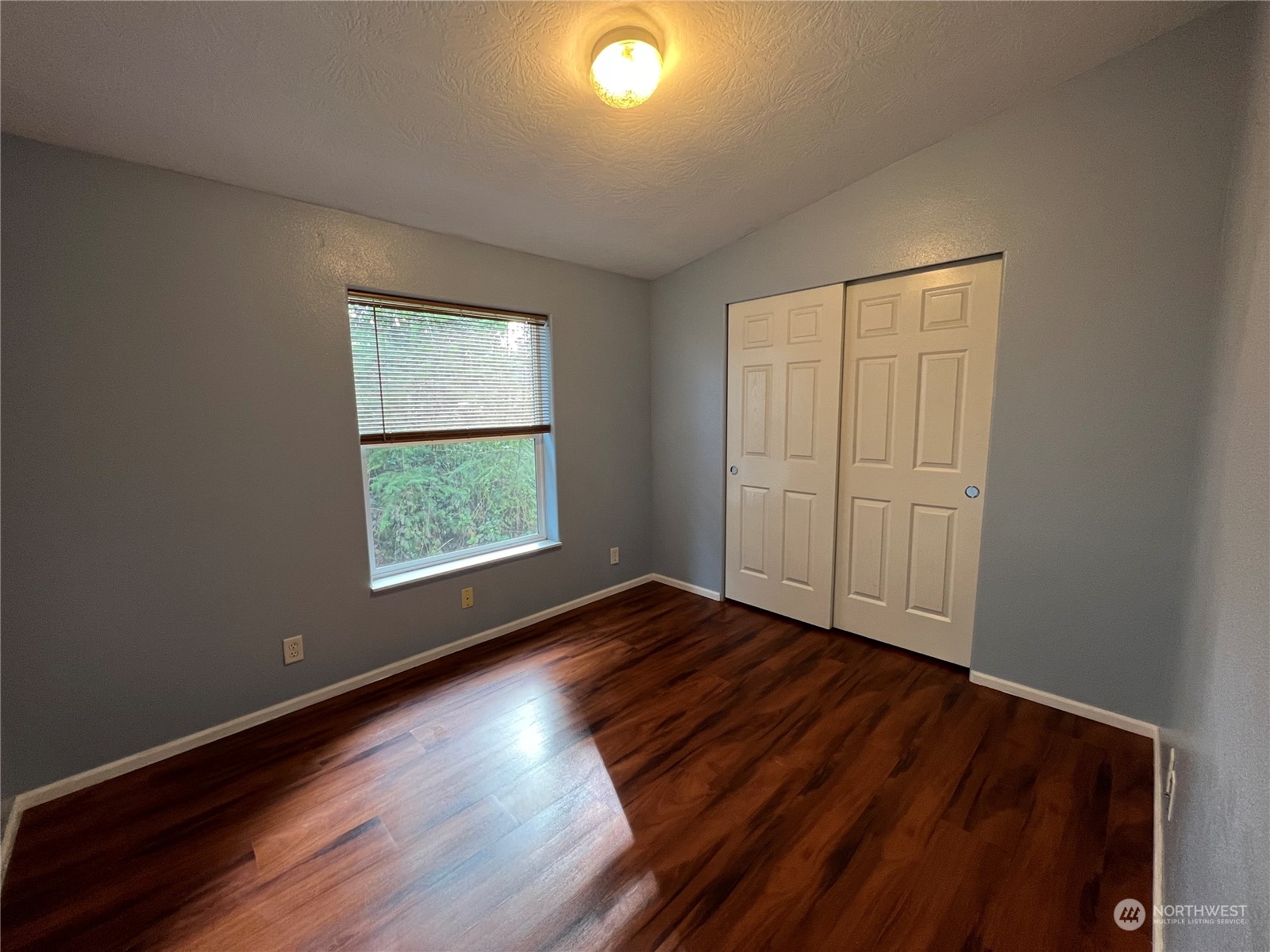827 Cousins Road, Unit 27 Chehalis, WA 98532 - Photo 26 of 38 an empty room with wooden floor and windows