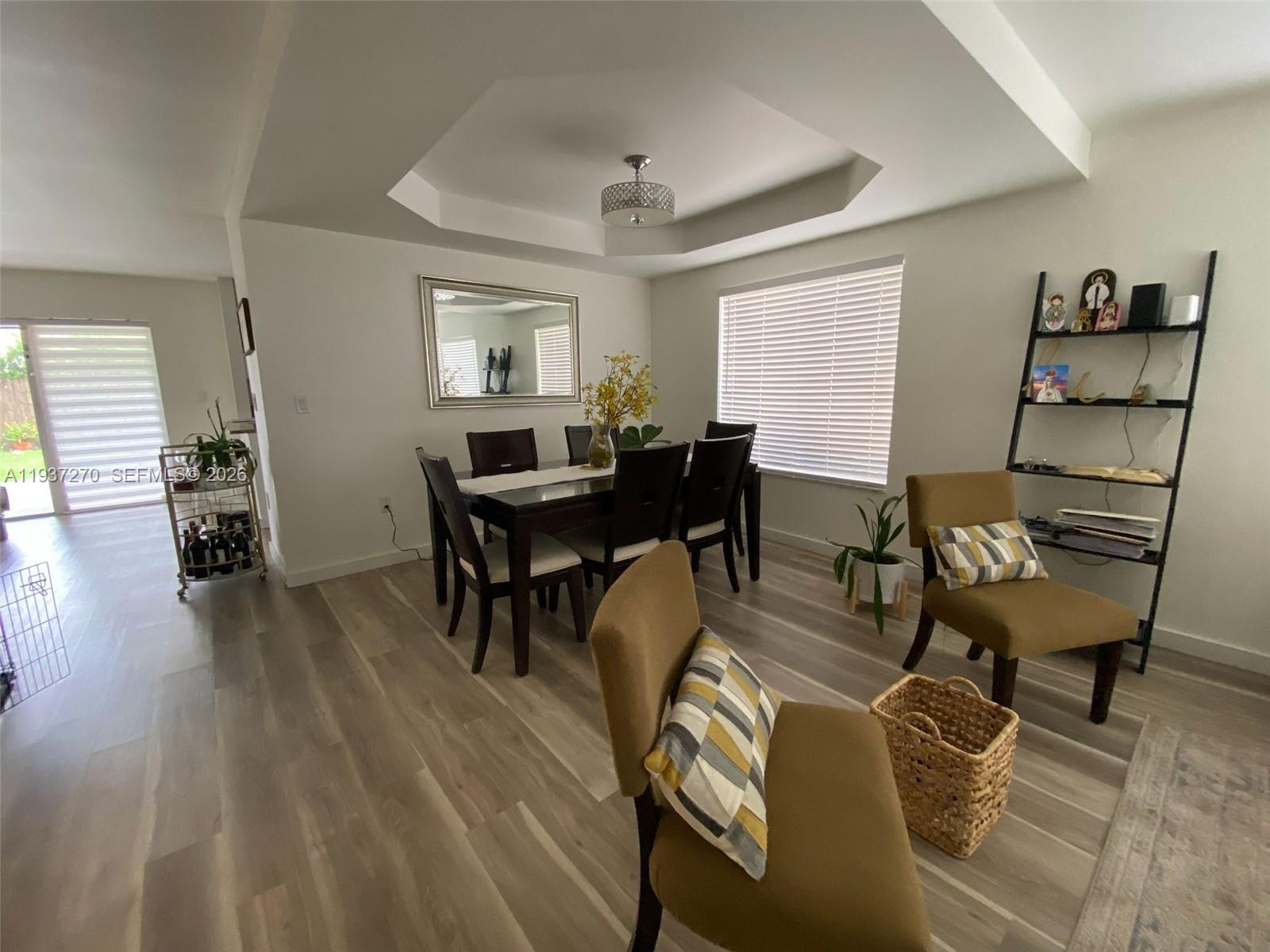15442 Southwest 139th Street Miami, FL 33196 - Photo 11 of 27 a view of a dining room with furniture and wooden floor