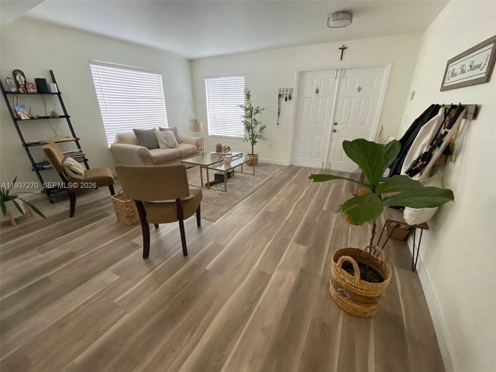 15442 Southwest 139th Street Miami, FL 33196 - Photo 14 of 27 a view of a livingroom with furniture and hardwood floor