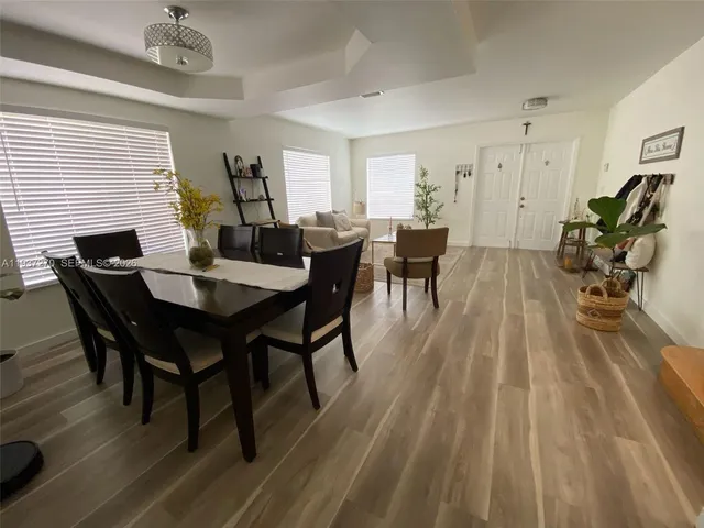 a view of a dining room with furniture and wooden floor