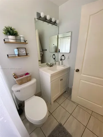 a bathroom with a toilet a sink and a mirror
