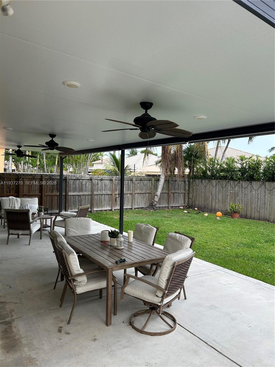 15442 Southwest 139th Street Miami, FL 33196 - Photo 24 of 27 a view of a patio with chairs and table in a yard