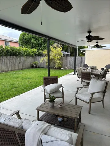 a view of a patio with table and chairs under an umbrella