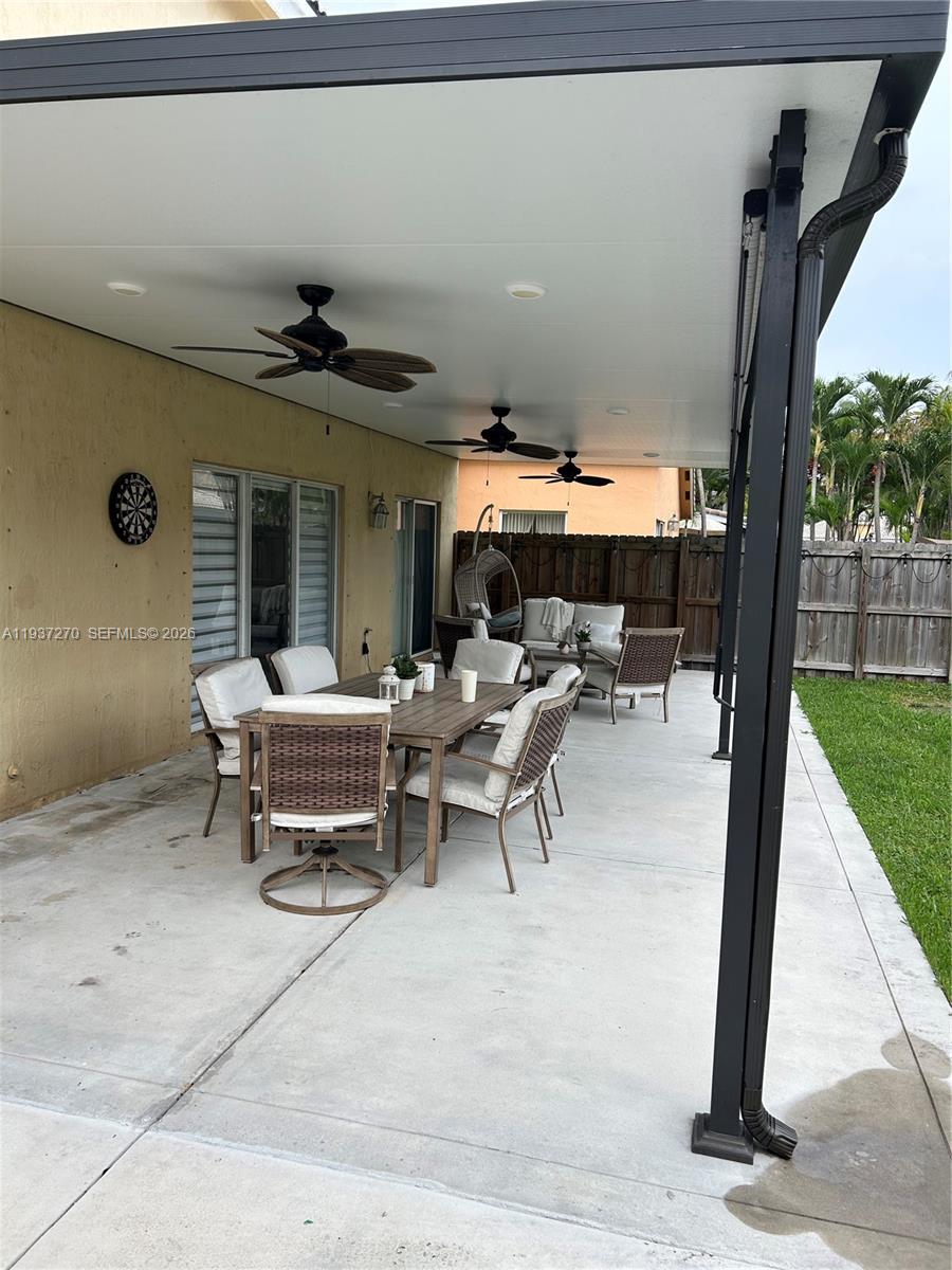 15442 Southwest 139th Street Miami, FL 33196 - Photo 27 of 27 a view of a patio with table and chairs potted plants with wooden floor