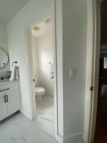 a spacious bathroom with a granite countertop sink toilet and shower